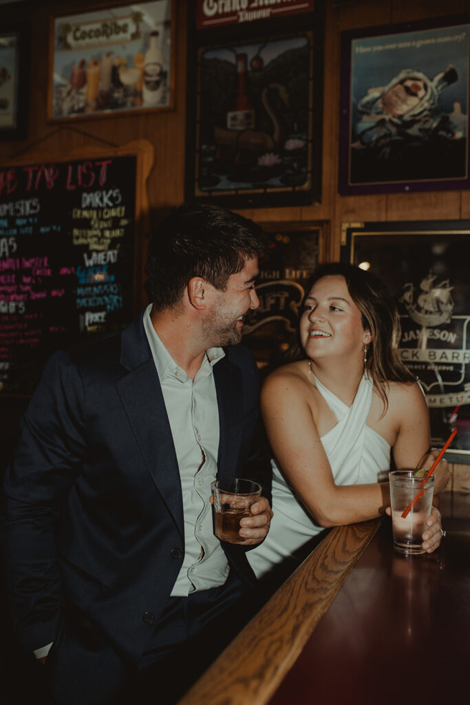 cute couple looking at each other at their chic engagement session