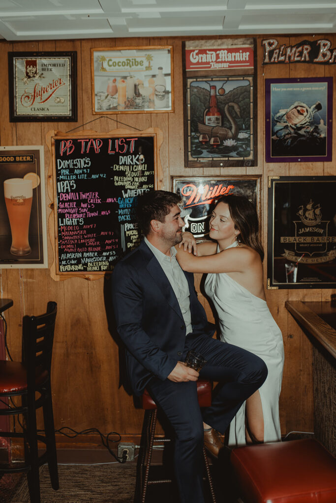 couple smiling at each other at their chic engagement session