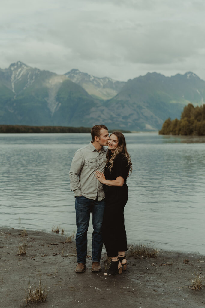 husband kissing his wife on the cheek 