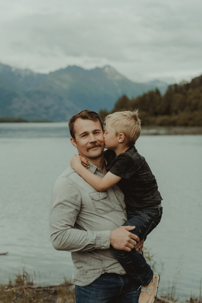 little boy kissing his dad on the cheek