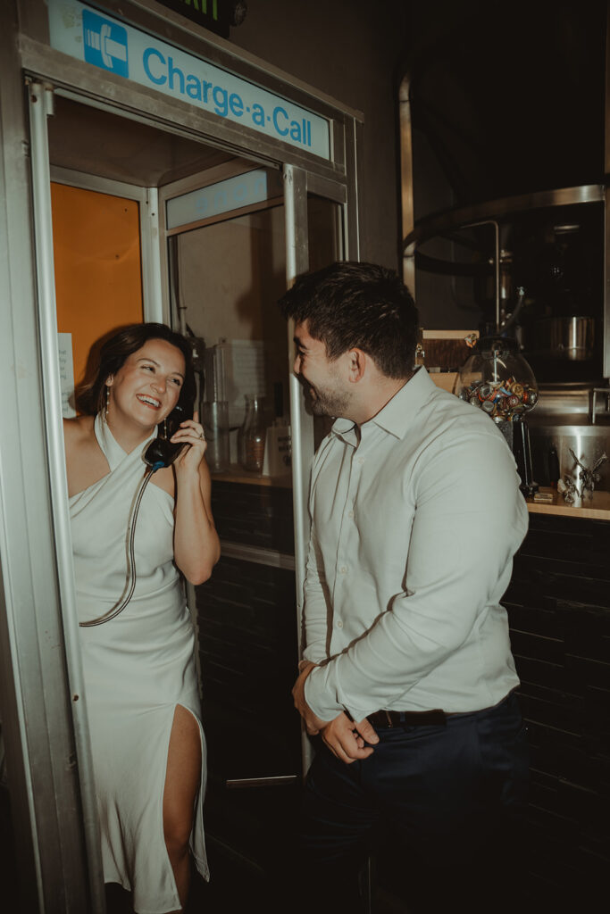 couple laughing with each other during their hometown photoshoot 