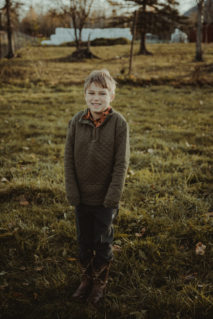 boy smiling at the camera during their photoshoot