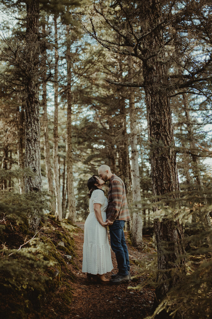 fiance kissing his fiance on the forehead at their fall engagement session