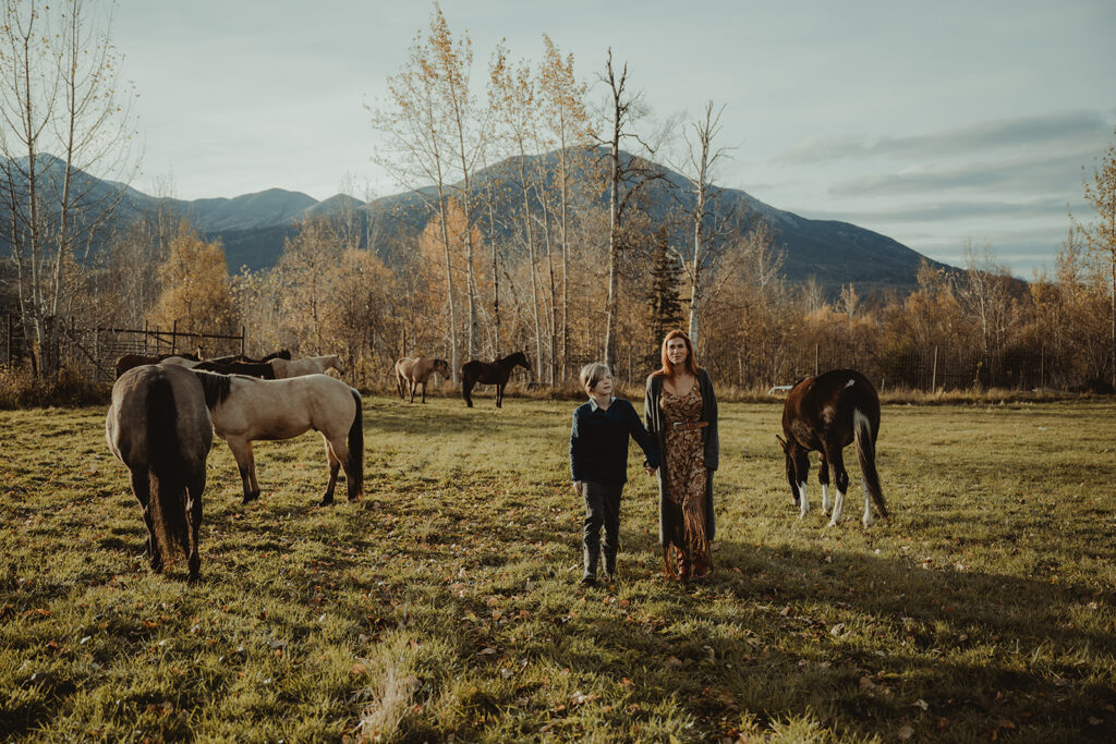 family holding hands walking around the ranch