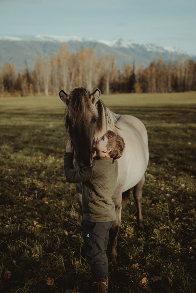 little kid playing with a horse