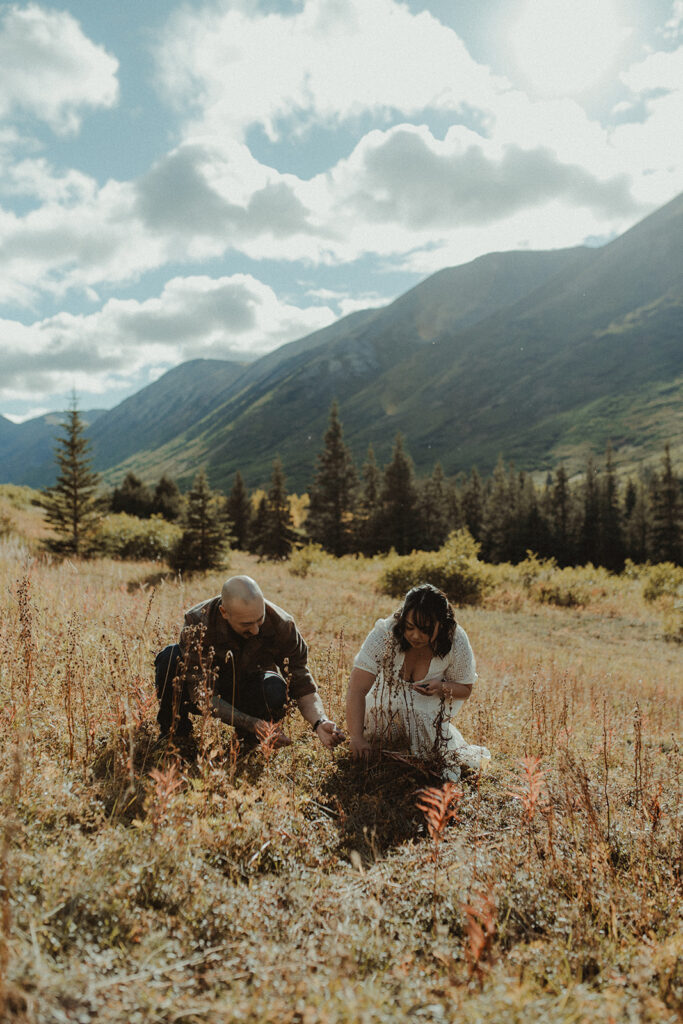 cute couple picking berries during their engagement session