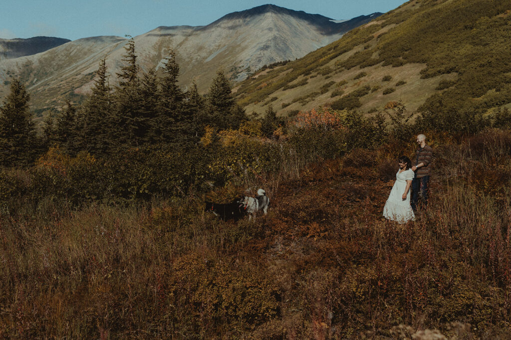 couple walking around with their dogs during their engagement session