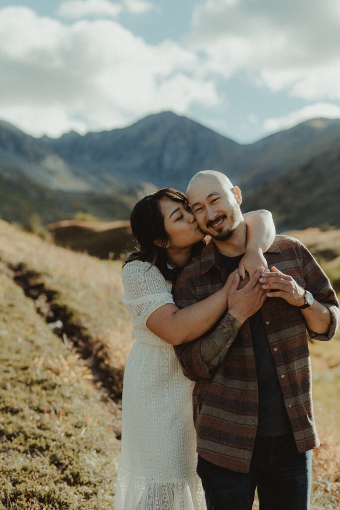 fiance kissing her fiance on the cheek