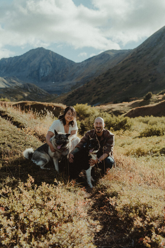 cute picture of the newly engaged couple with their dogs 