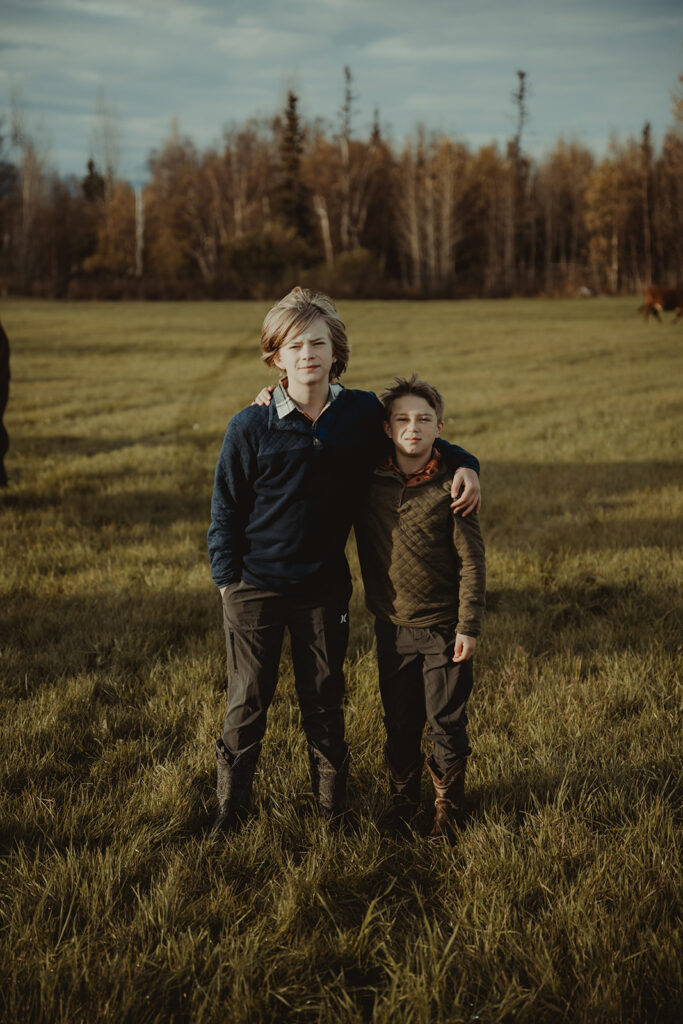 sibling hugging during their sunrise family photoshoot