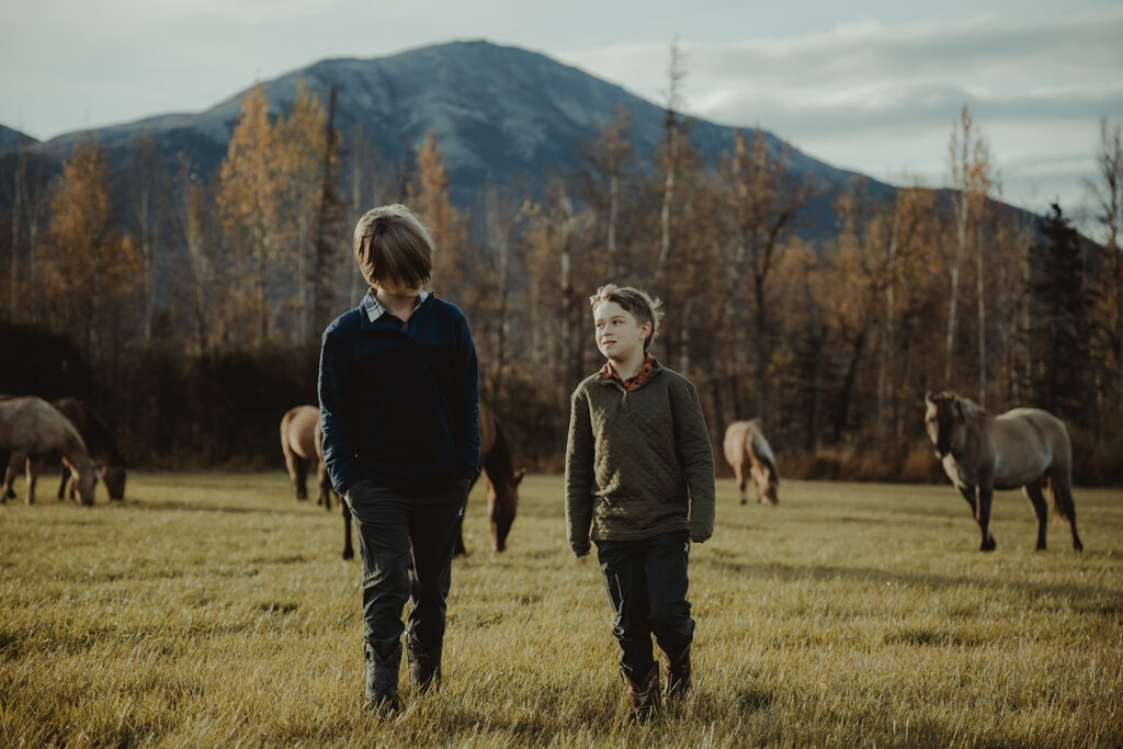 siblings walking around the ranch 