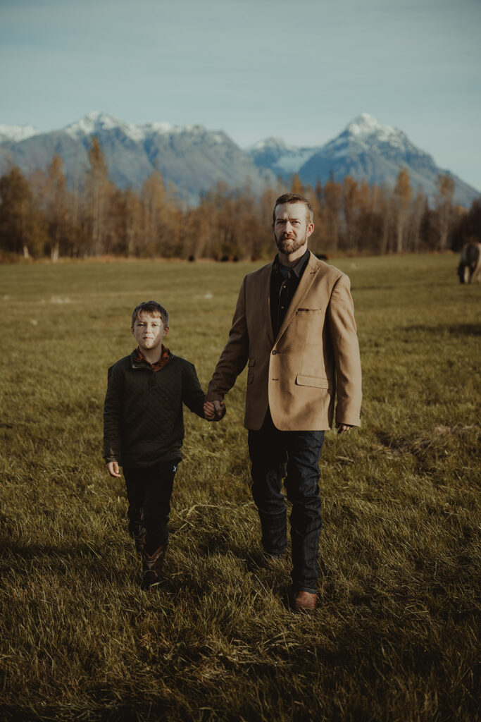 dad and his son walking around the ranch 