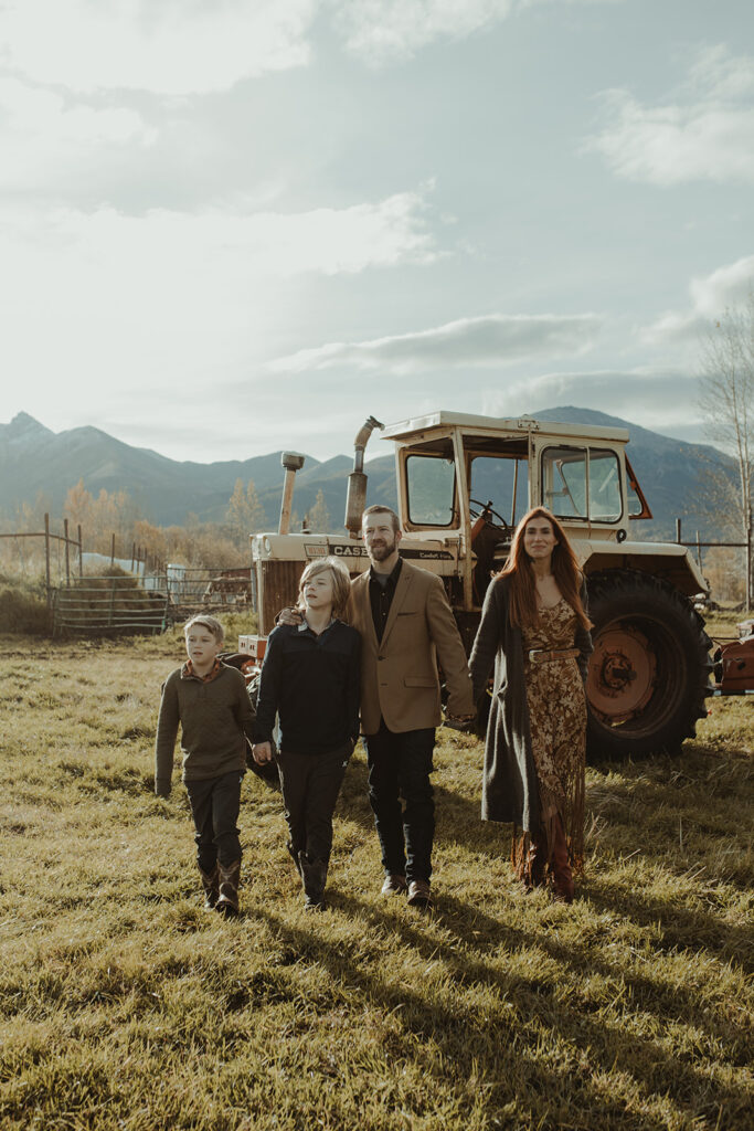 family smiling at the camera during their photoshoot