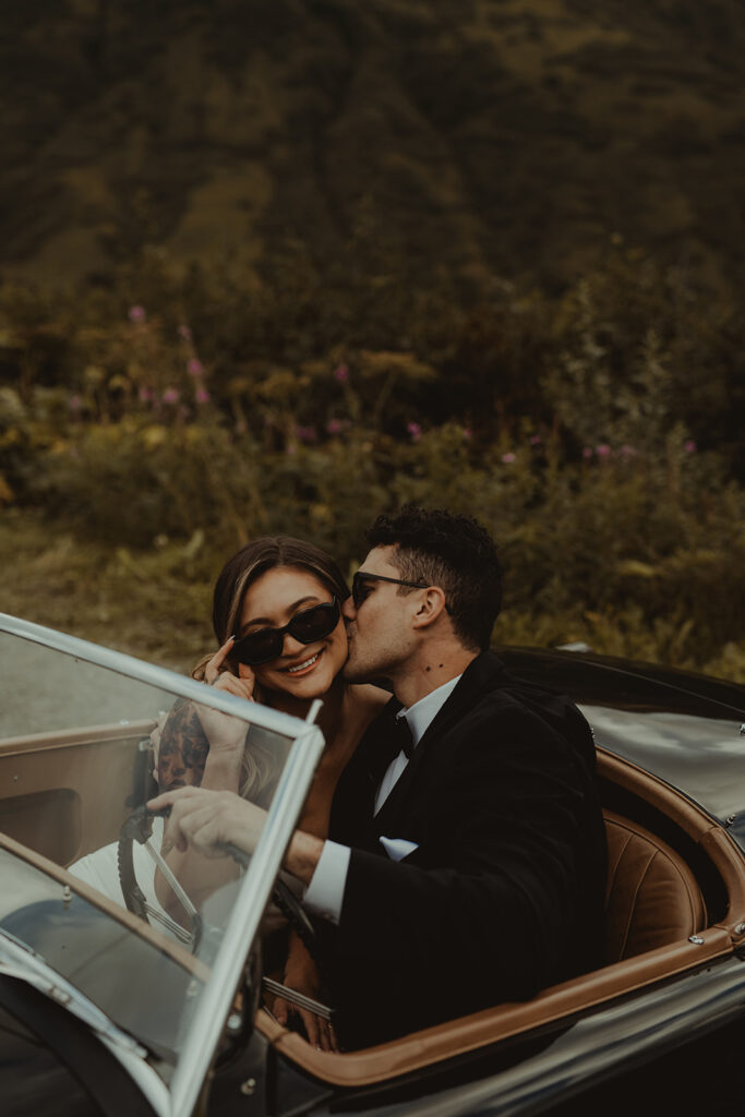 groom kissing the bride on the cheek