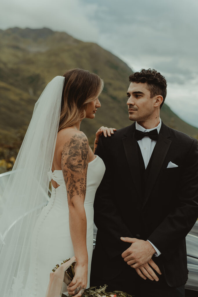 bride and groom smiling at each other