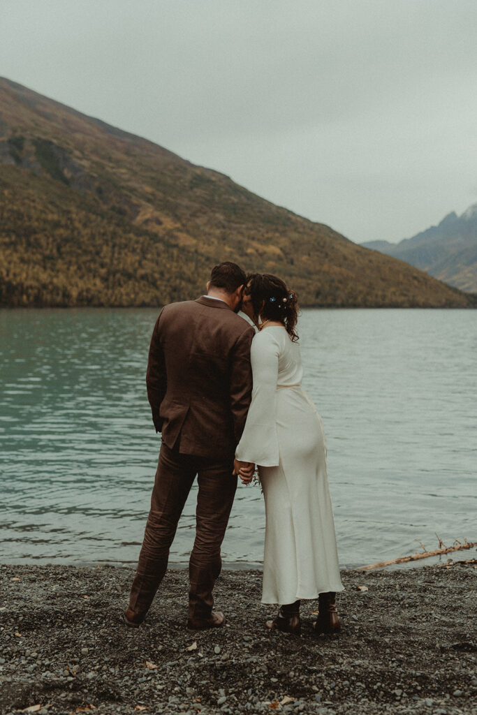 Couple embrace along the shores of alaska's breathtaking Eklutna Lake